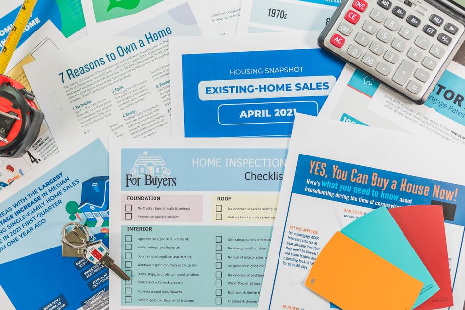 Brochures, checklists, and a calculator flat lay
