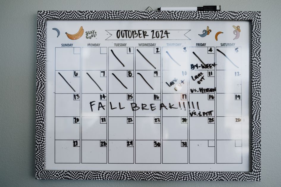 A whiteboard calendar with a fall break note