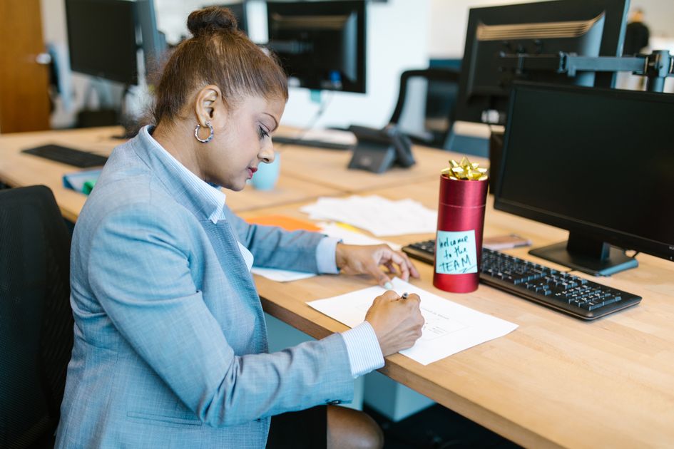 A focused woman working at her desk in a modern office