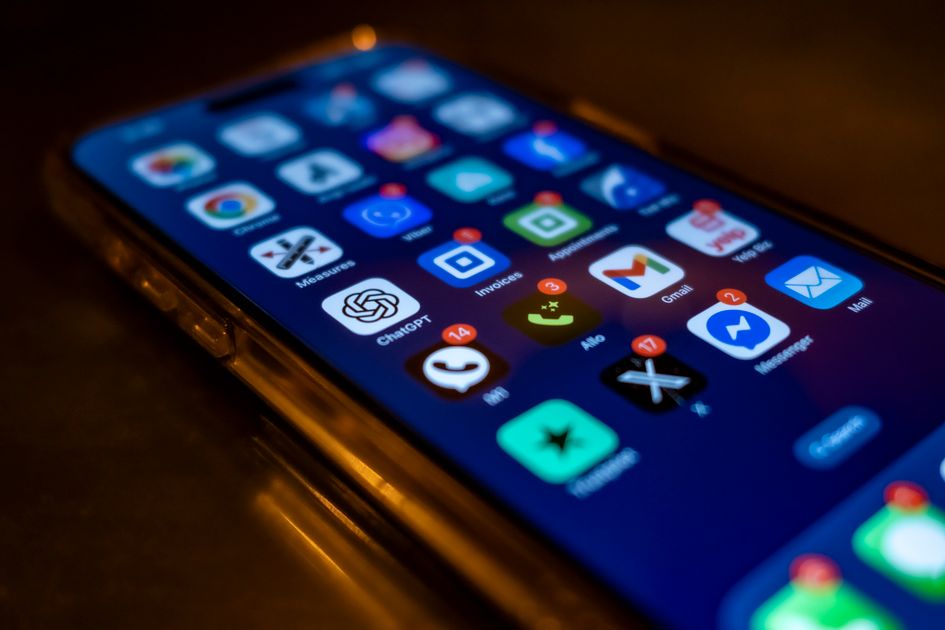 A smartphone screen showing app icons with notification badges