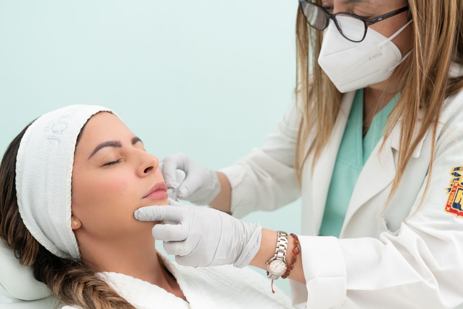 A doctor performing a cosmetic treatment in a clinic