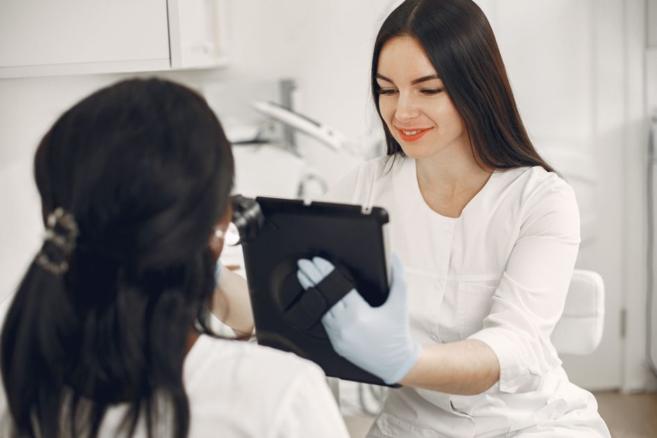 A beautician consulting a client using a tablet
