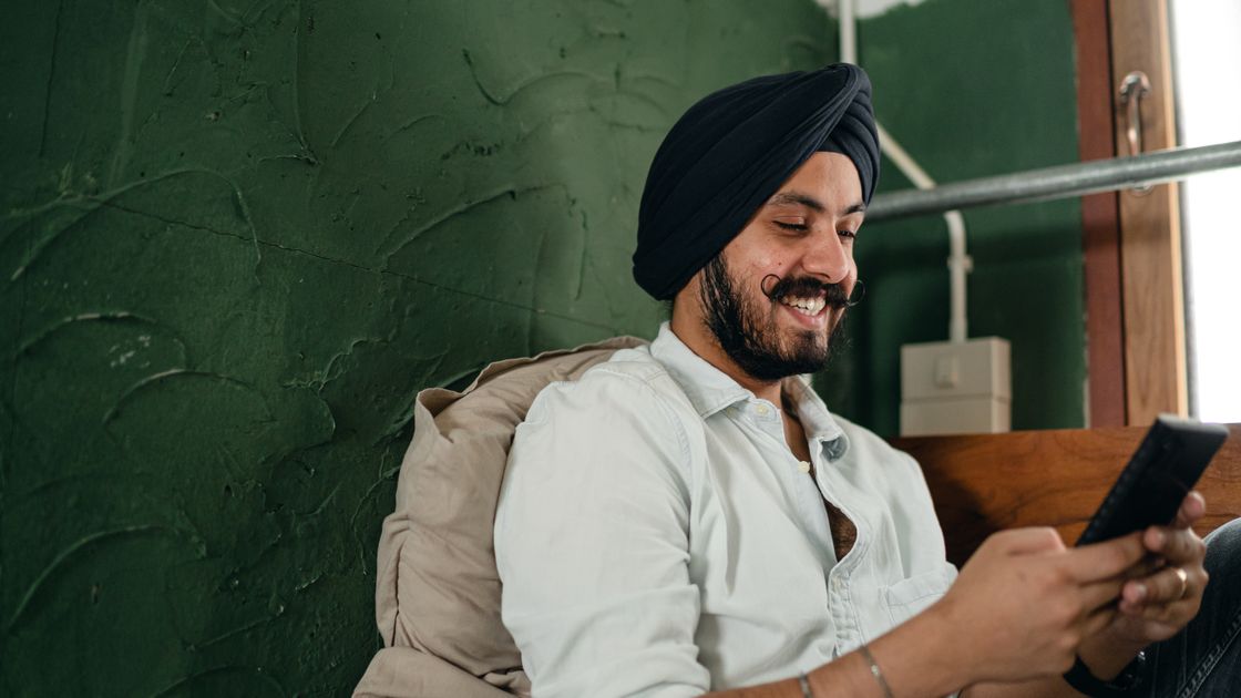A man browsing the internet on his smartphone at home