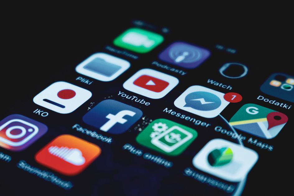 A close-up of social media app icons on a smartphone