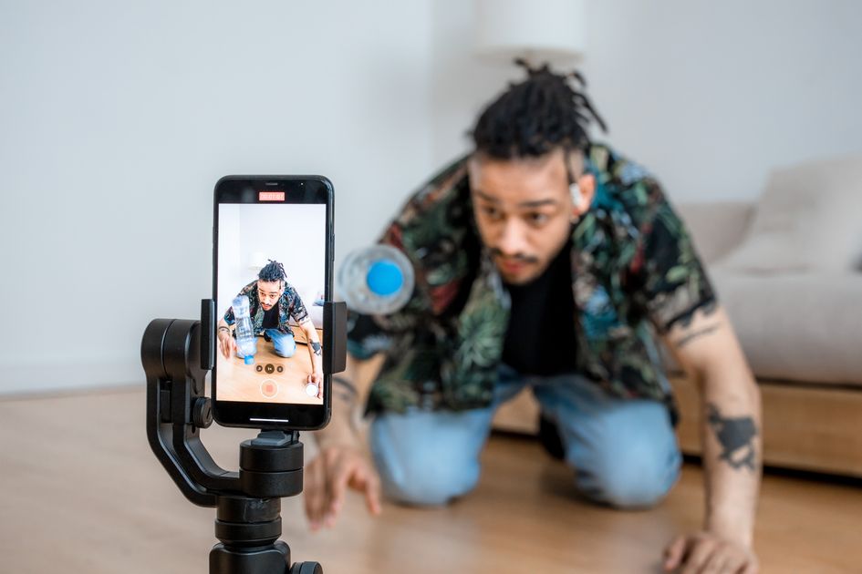 A person filming content with a smartphone on a gimbal