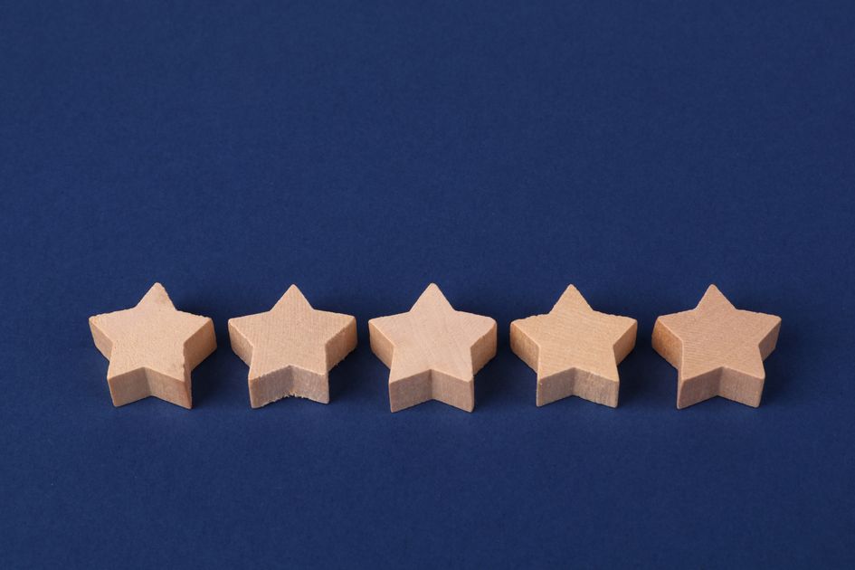 Five wooden stars on a blue background representing a rating system